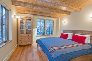The king master bedroom features beautiful wood floors and ceilings.