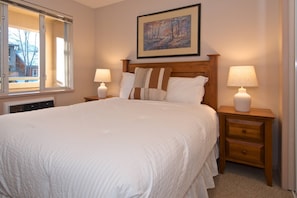 Queen bed with new linens and plush duvet