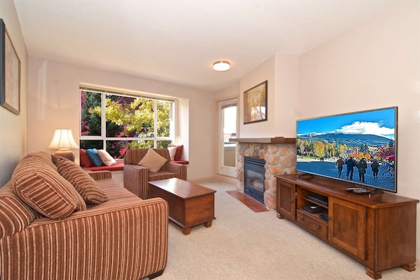 Comfortable living area with sofa bed, window seat and 52" TV