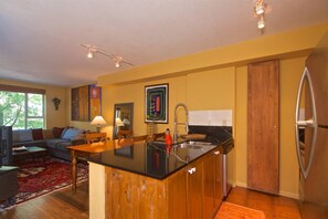 Another view of the kitchen over looking into living area