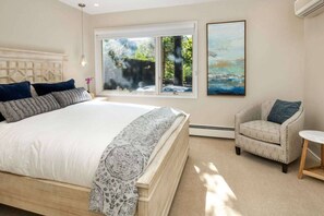 Soothing colors and an inviting view offer relaxation in the air conditioned queen bedroom.