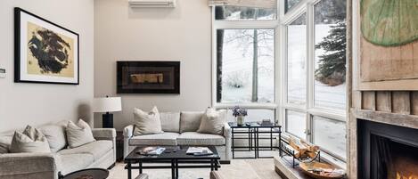 Enjoy a view of the ski slope from the cozy living room in this Aspen Mountain slopeside condo