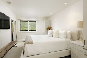 A serene escape, this newly remodeled master bedroom has a spacious king bed and lots of great storage.