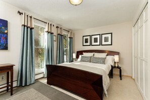 In the queen bedroom there are floor to ceiling windows to let in the warm sun and provide a beautiful view of the majestic trees outside
