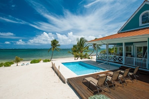 Lounge by your private pool with a gorgeous view of the Caribbean.