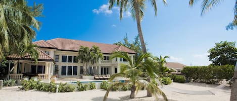 Welcome to Coconut Walk, an oceanfront estate on Seven Mile Beach. 