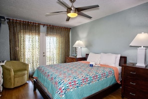 Master bedroom features a comfortable Queen-size TempurPedic bed and access to the patio.