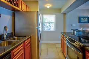 Fully equipped kitchen with stainless steel appliances and granite counter tops.