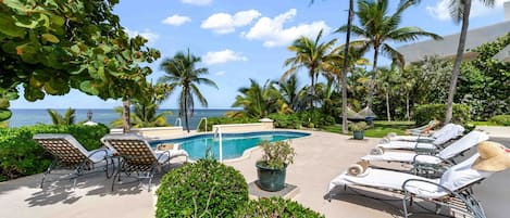 Private pool with sun loungers and ocean views. 