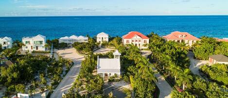 Aerial view of Nutmeg Cottage (white) facing Grace Bay Beach.