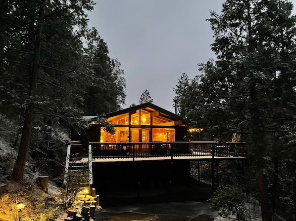 Exterior of the home. Parking is located below the deck. - Welcome to the Spinning Wheel! This home is nestled in the pines and waiting your arrival