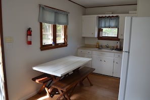 Full kitchen w/ dining table and benches