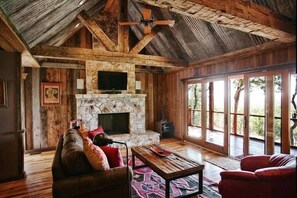 Cozy up next to the gorgeous stone fireplace while still enjoying spectacular views!