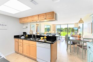 Cook with ease in this open kitchen while enjoying water views nearby