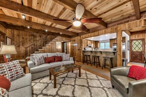 The cozy living room area opens to the kitchen and dining area