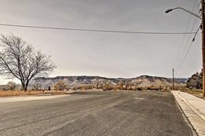 The home is nestled on a quiet, residential street surrounded by farmland.