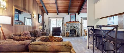 Living room with TV, DVD player, wood burning fireplace