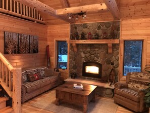 cozy living room with wood fireplace to warm you on cold nights