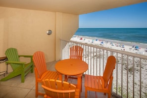 Table seating on the tiled, Gulf-front balcony.