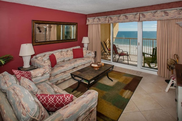 Living area with sofa sleeper and direct access to the Gulf-front balcony.