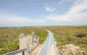 The beach is a short walk through the lush sand dunes. Our sand pad makes pulling your ice chest or wagon a breeze.