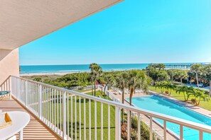 Relax on the balcony with direct ocean views overlooking cocoa beach pier