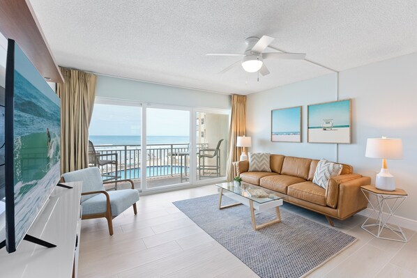 Relax in this stylish and airy living space, featuring modern decor, a cozy seating area, and breathtaking oceanfront views.