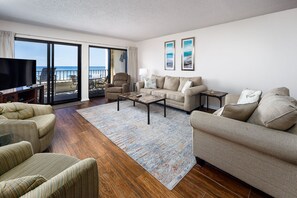 Living Room View - Large open space with a 50" smart Samsung tv, plenty of seating and an amazing view of the gulf.