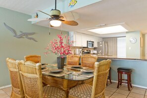 Our beachy dining area seats 6 around the table and 4 at the breakfast bar.