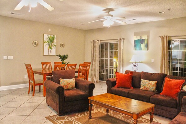 Open-concept living and dining space with warm tones and direct access to the patio—perfect for family meals and movie nights.