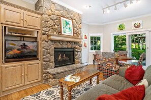 Perfect lounging area off kitchen with table seating for 4, gas fireplace and flat screen TV/DVD. French doors lead to additional outdoor seating