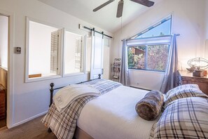 Spacious and Bright Guest Suite has a Queen Bed, Mountain Views, Large hardwood dresser for storage, ceiling fan, Barn Door, Loft shutters for privacy