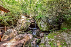 A nature lovers dream! There is one waterfall as pictured here and another one flowing just beneath the cabin.