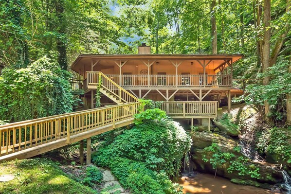 Waterfall Cabin! This unique cabin is literally built over a waterfall. New updates include exterior paint, new hot tub, new beds, interior paint, and