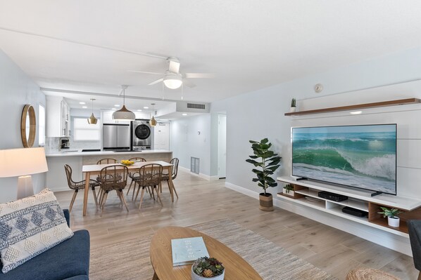 Stylish open-concept living space with coastal-inspired decor, and a spacious layout.