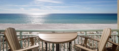 IT'S ALL ABOUT THE VIEW - BAR HEIGHT CHAIRS AND TABLE LET YOU LOOK OVER THE RAILING AT THE STUNNING GULF AND BEACH SERVICE. FOUR EXTRA CHAIRS IN CORNER.