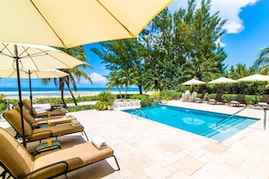 Pool deck with plenty of loungers and shade umbrellas.