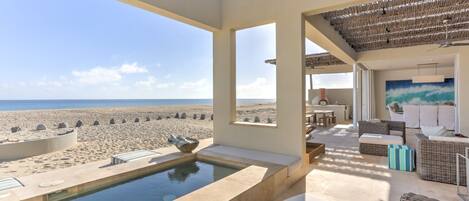 The hot tub has beautiful views of the beach & ocean.