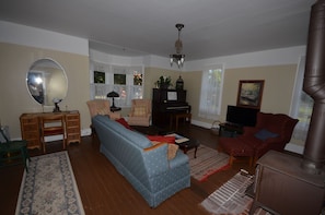 Living room with wood stove. - Living room with wood stove.