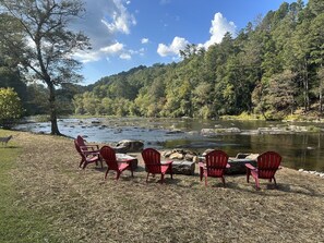 Gather around the firepit at the banks of the Coosawattee River in Ellijay