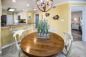Dining area - The round table seats 4 - lovely space saver. All chairs have the yellows and blues to match the living room set