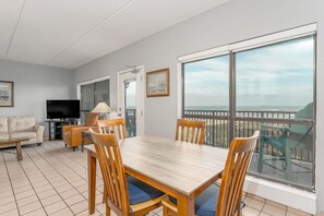 Floor-to-ceiling windows flood the dining space with light, showcasing breathtaking beachfront views that elevate every mealtime experience. 