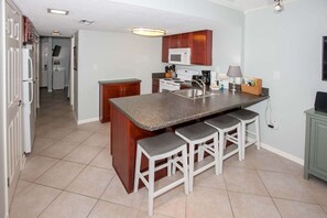 Fully equipped kitchen with seating for four at the breakfast bar