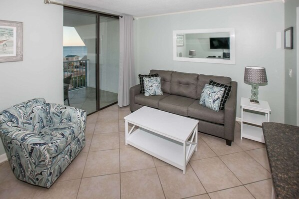 Comfortable living room with a sleeper sofa and balcony access