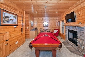 Game room downstairs offers a pool table, fireplace, bar area and additional seating