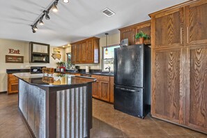 Full kitchen with a large bar area