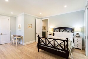 Queen Bedroom with queen bed, tv, writing desk and attached bathroom