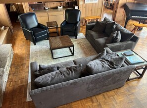Living area with piano and gas fireplace. - Living area with piano and gas fireplace.