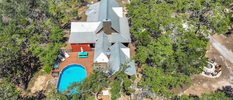 Aerial view of the property showing the pool and deck on the rear of the house.!