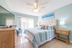 Serene master bedroom with a plush king bed and ocean-inspired decor.